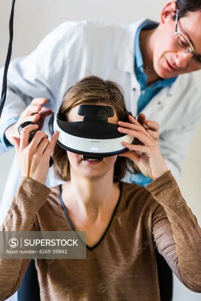 Woman during a session of virtual reality therapy to treat phobia. Department of Psychiatry, Pitie-Salpetriere hospital, Paris, France.