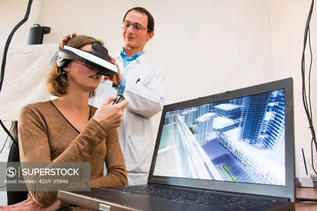 Woman during a session of virtual reality therapy to treat acrophobia or extreme fear of heights. Department of Psychiatry, Pitie-Salpetriere hospital, Paris, France.