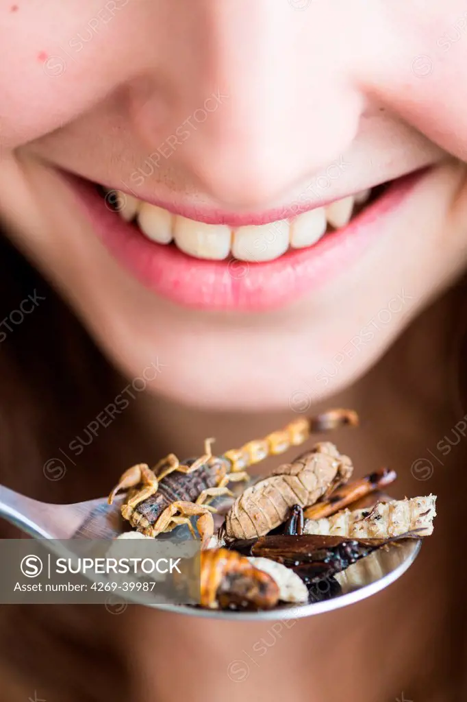 Woman eating edible insects.