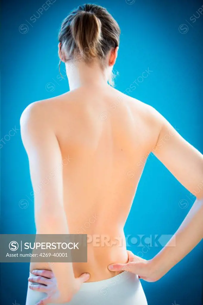 Woman suffering from lumbar pain.