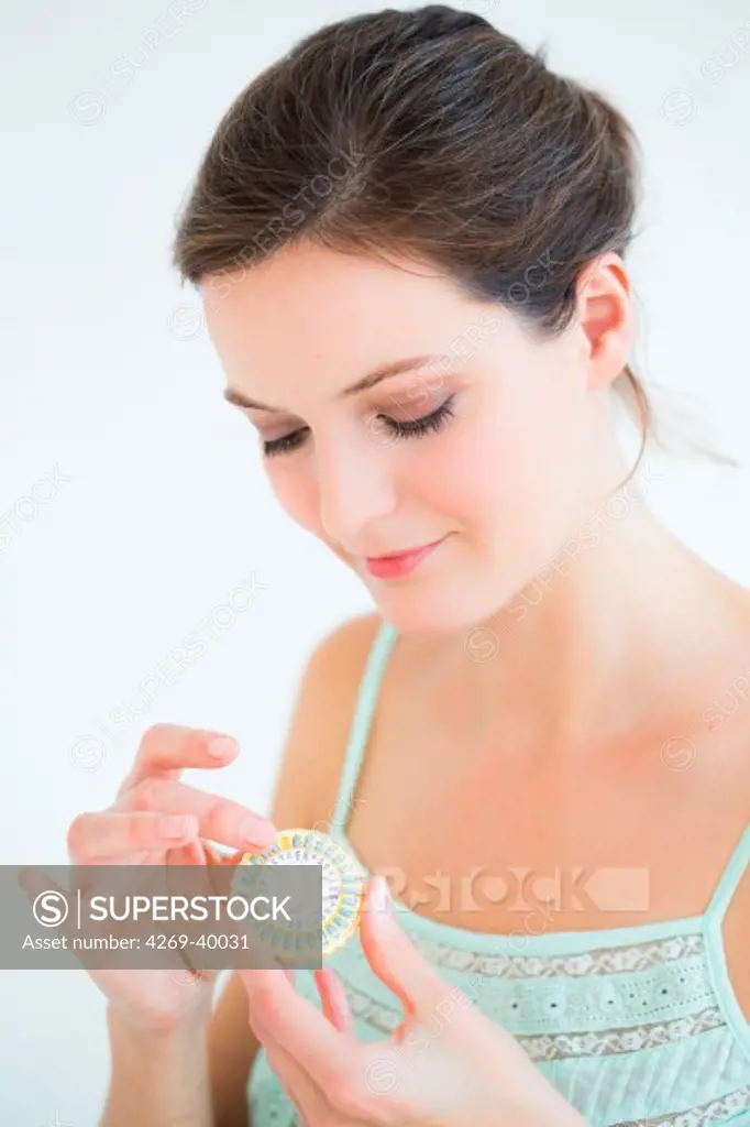 Woman taking an hormone replacement therapy pills.