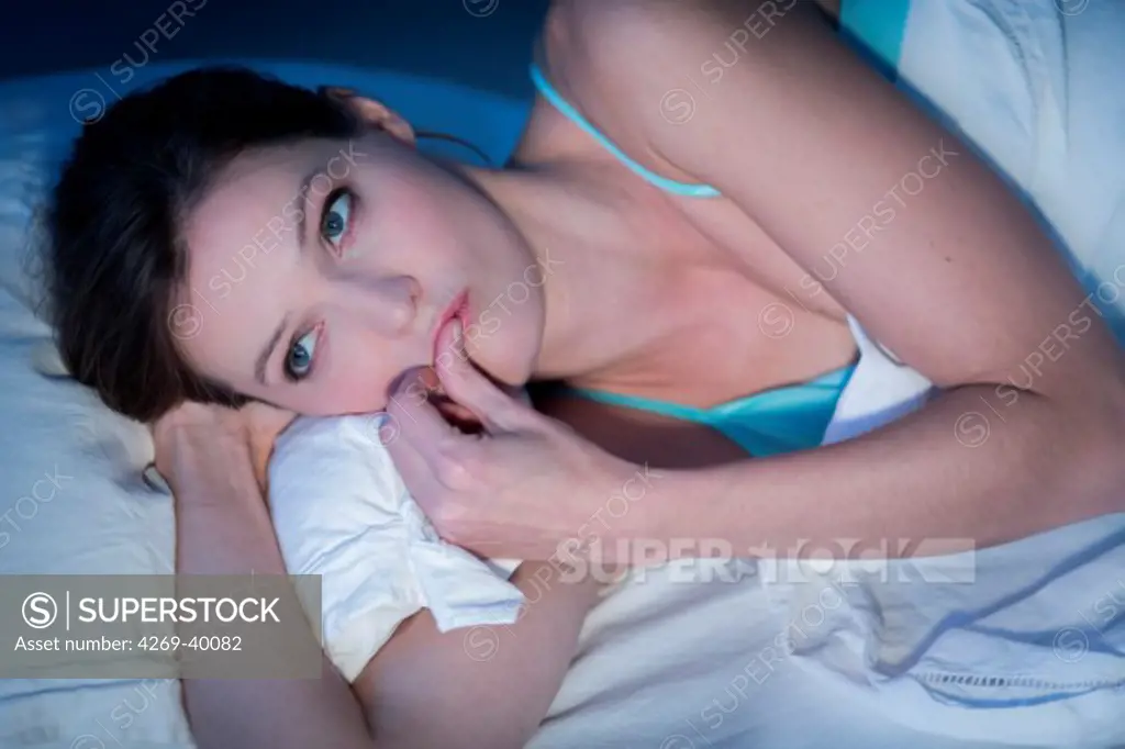 Woman resting in bed.
