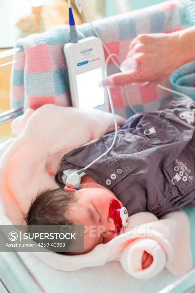 Newborn baby undergoing deafness screening test, Angouleme hospital, France.
