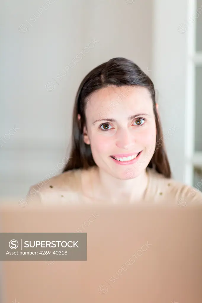 Woman using a laptop.