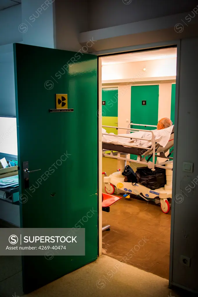 Male patient waiting in a hospital corridor.