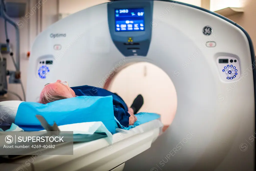 Male patient undergoing a CT scan, Croix Saint Simon hospital, Paris, France.