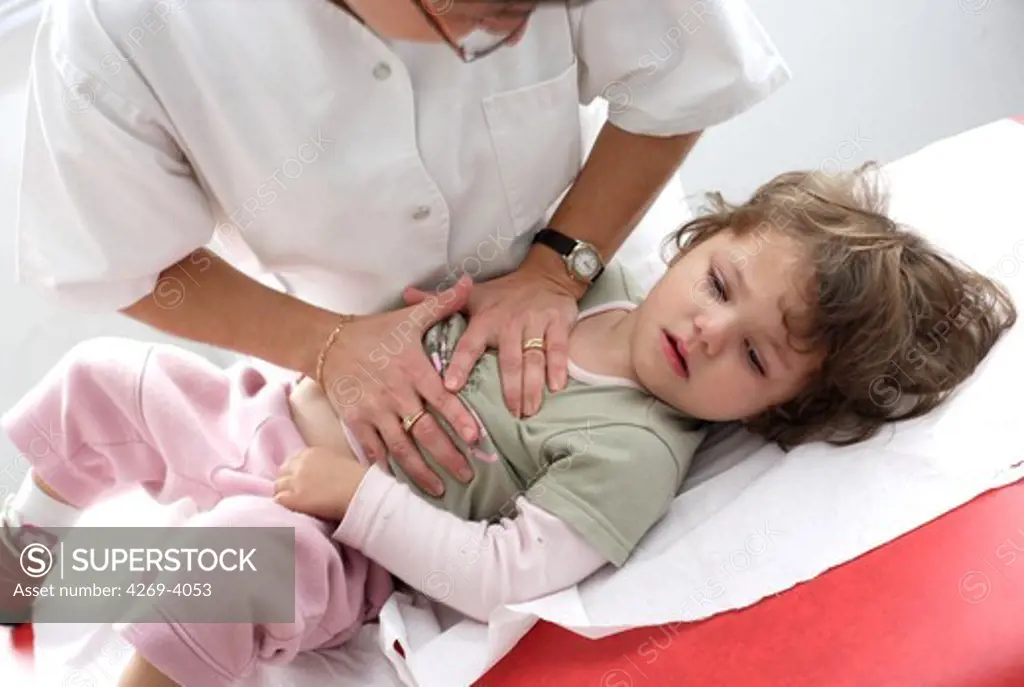 Physiotherapist performing lungs massages on a 28 months old baby girl in order to increase the expired air capacity, in case of obstruction of the bronchus.