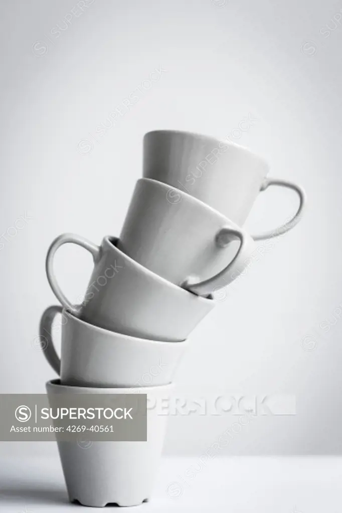 Stacked cups illustrating excessive consumption of coffee.