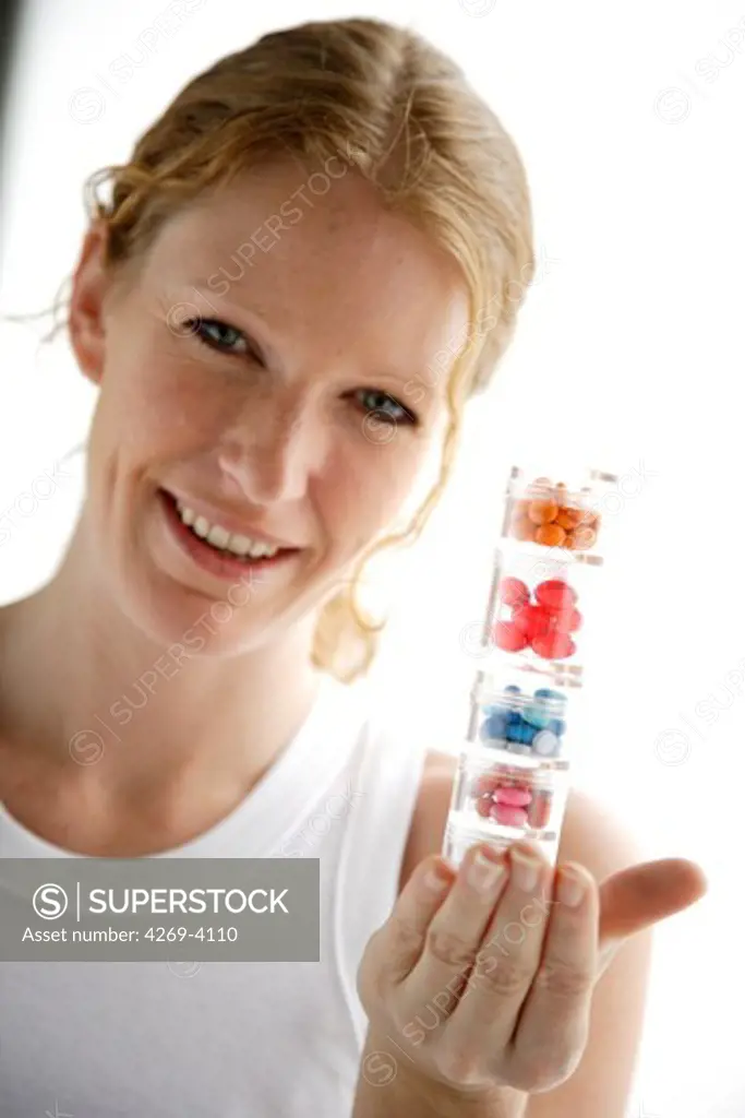 Woman holding medications.