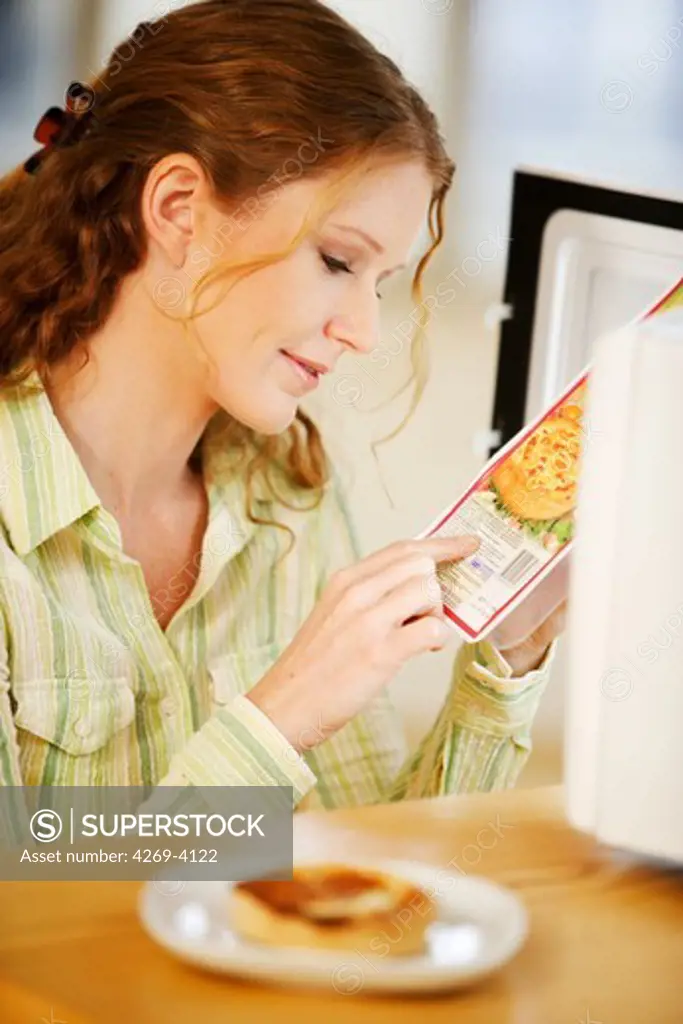 Woman checking the composition and nutrition facts.