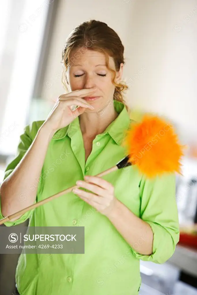 Woman sneezing from dust.