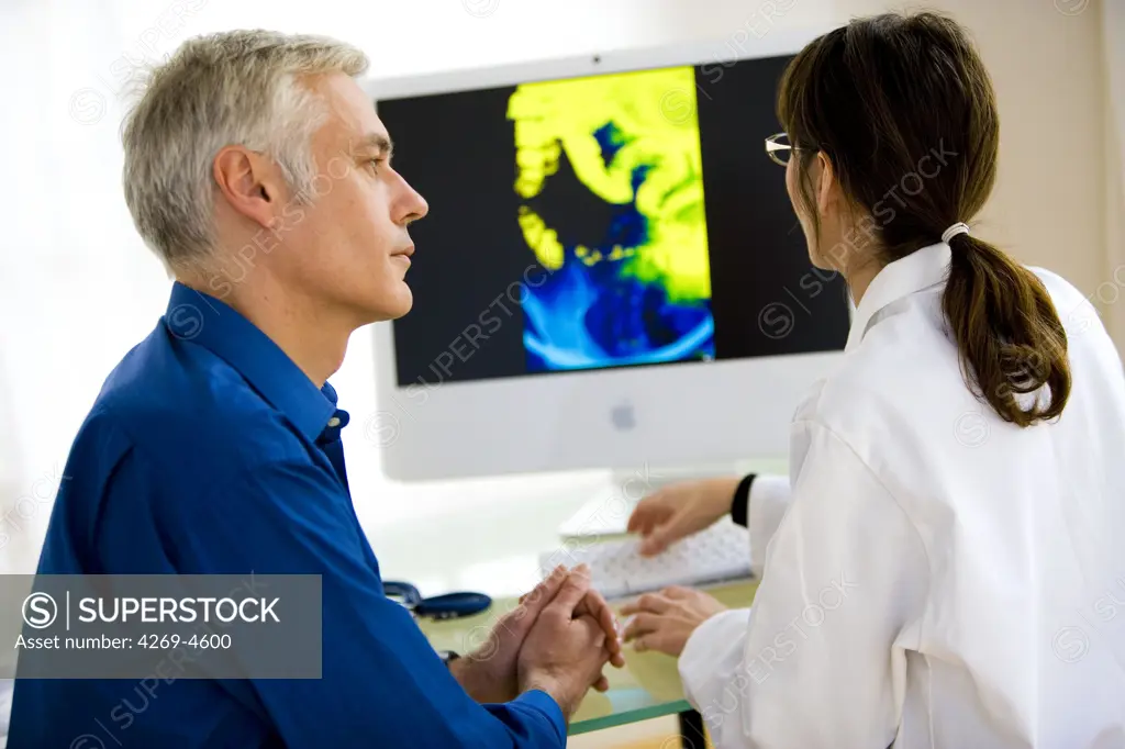Doctor discussing a bowels X-ray with a patient.