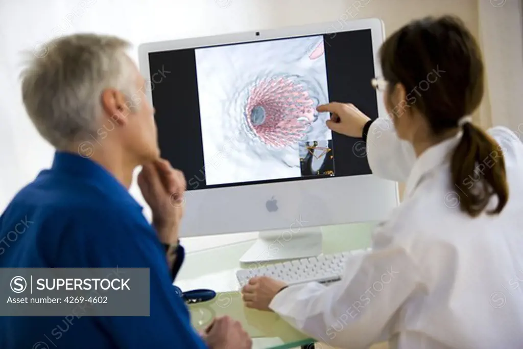Doctor showing a patient virtual endoscopy of a stent vascular prosthesis.