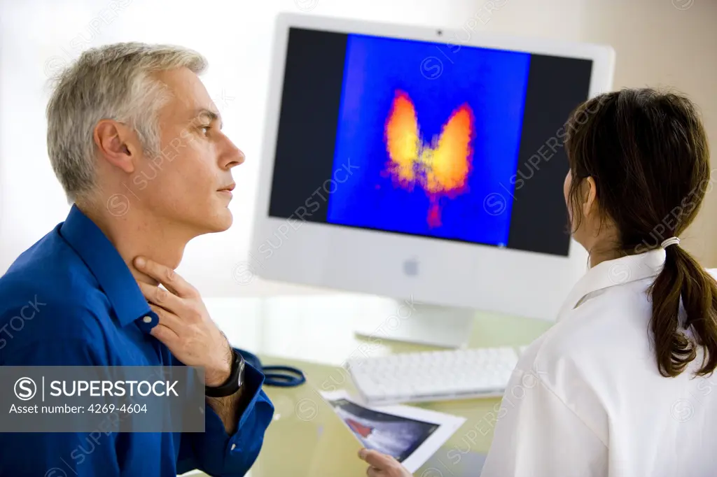 Doctor discussing a thyroid gland scintigram with a patient.