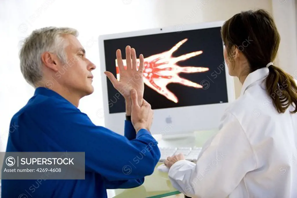 Doctor discussing hand X-ray with a patient.