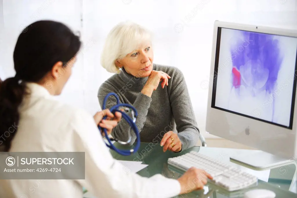 Doctor discussing hip arthritis X-ray with a patient.