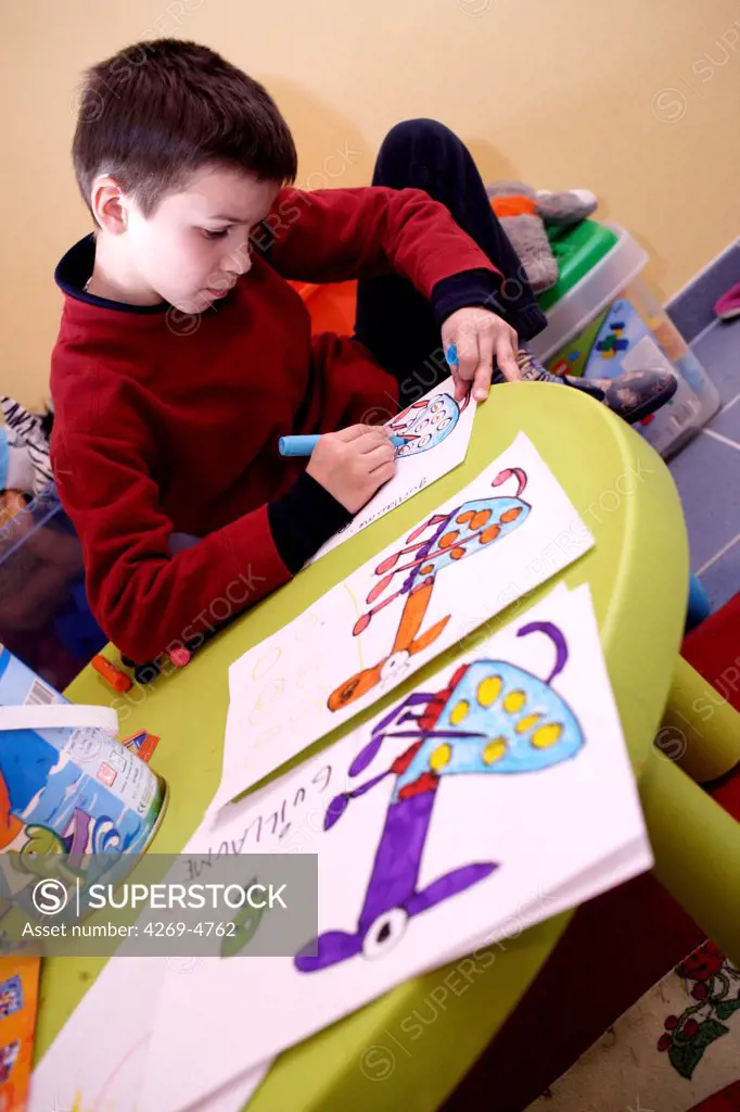 The Maison Forestière is a weekly boarding facility for heavily autistic children from 6 to 14 years old in Montmoreau, France. They receive a global therapy based on daily activities and specific educational workshops helping them to develop social, play, and learning skills. Here, autistic child drawing.