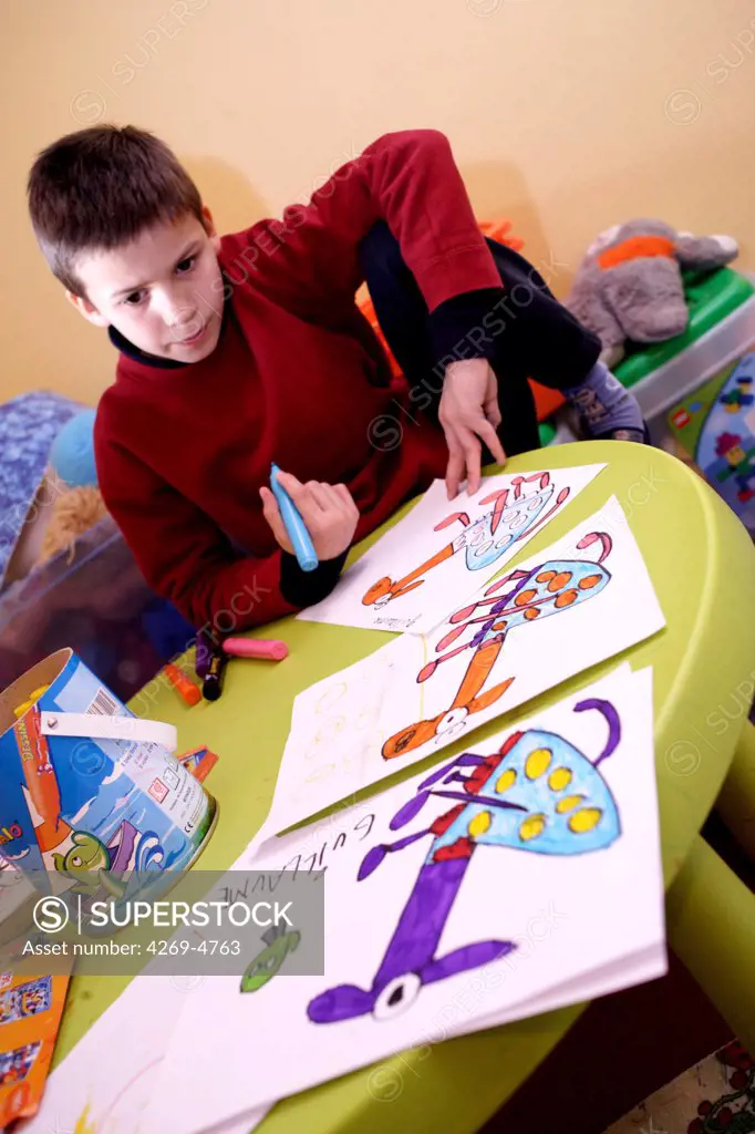 The Maison Forestière is a weekly boarding facility for heavily autistic children from 6 to 14 years old in Montmoreau, France. They receive a global therapy based on daily activities and specific educational workshops helping them to develop social, play, and learning skills. Here, autistic child drawing.