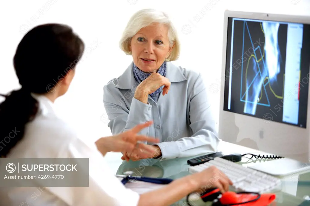 Doctor discussing bone densitometry x-ray of the hip with a patient.