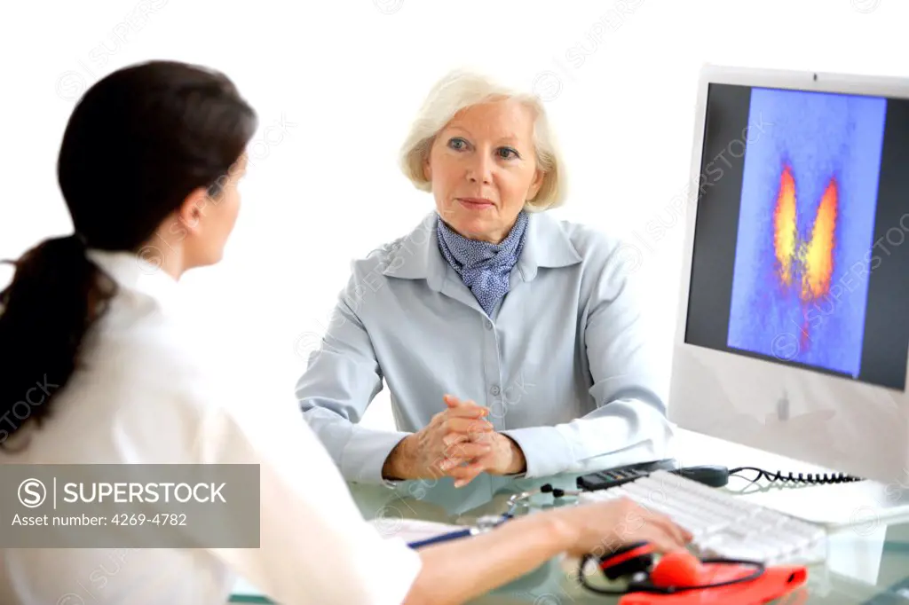 Doctor discussing a thyroid gland scintigram with a patient.
