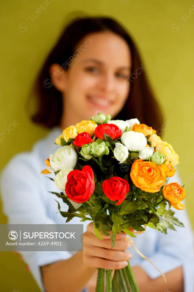 Woman holding bunch of flowers.