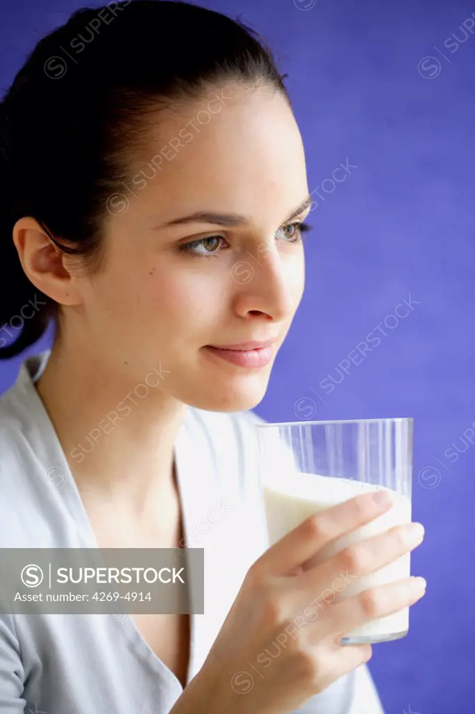 Woman drinking a glass of milk.