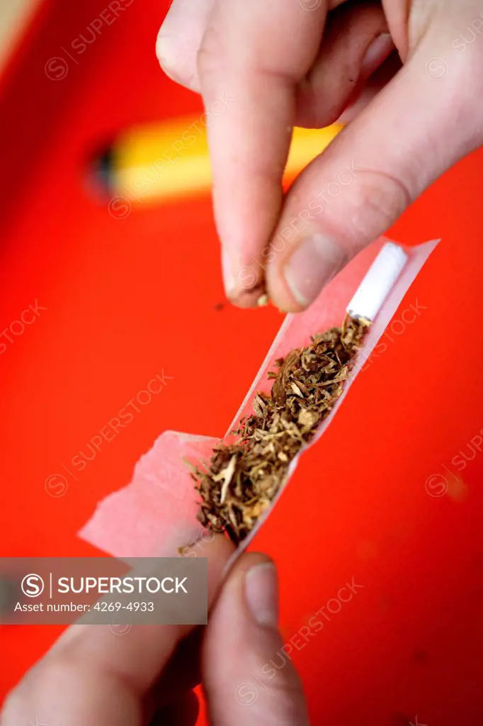 Man rolling a joint.