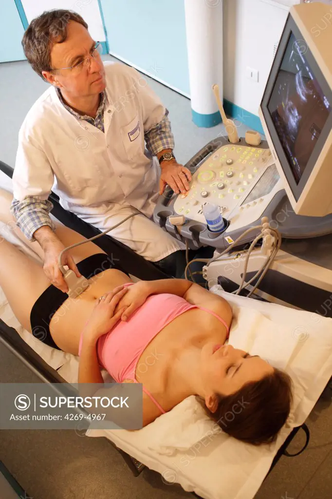 Woman undergoing pelvic ultrasound scan.