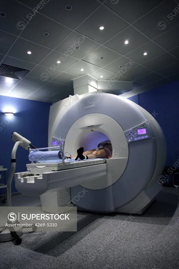 Lens Hospital, France. Patient undergoing MRI scan in the first high field ultra short bore MRI. The high height of the bore of the device makes it accessible for obese patients (weight up to 250 kg), pregnant women or claustrophobic patients.