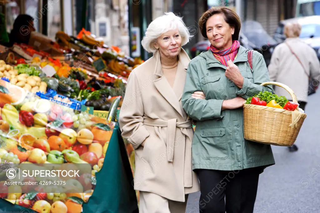 Woman and elderly woman shopping for fruits.