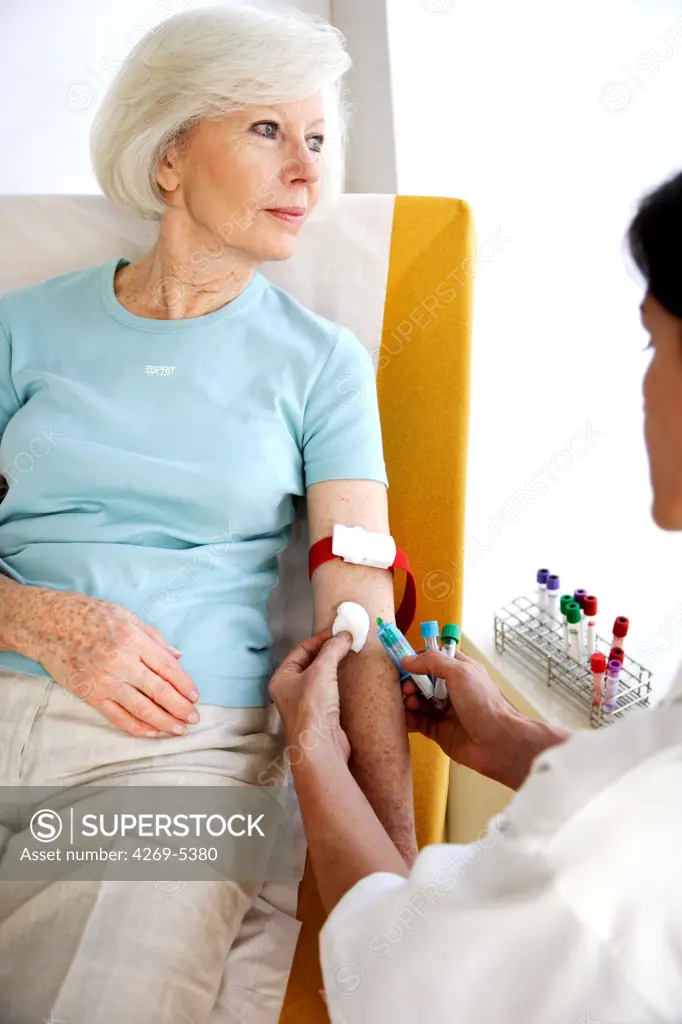 Elderly woman having blood sample.
