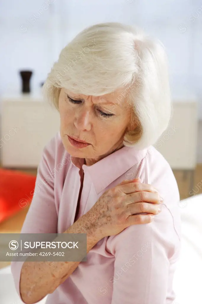 Elderly woman suffering from shoulder pain.