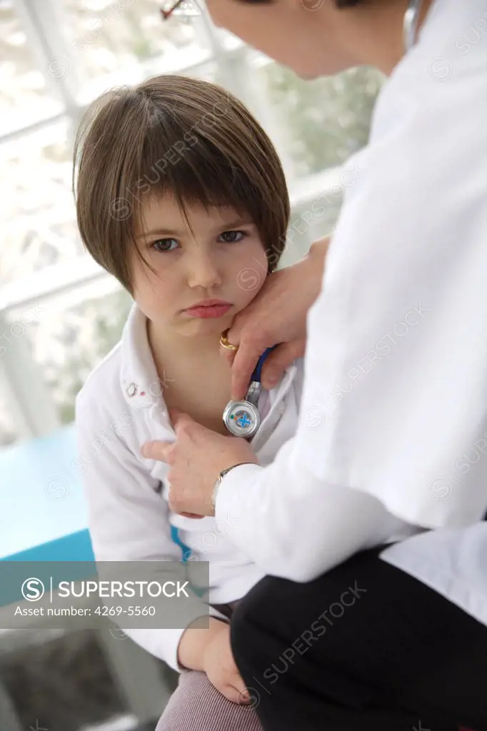 Doctor examining a 5 years old girl with a stethoscope.