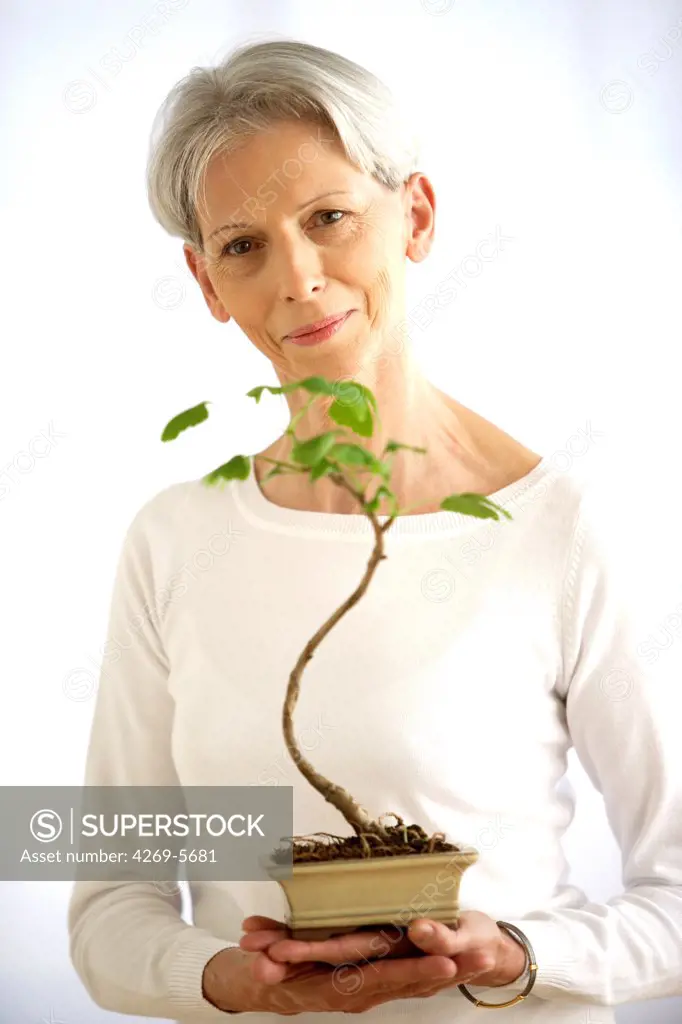Woman with bonsai.