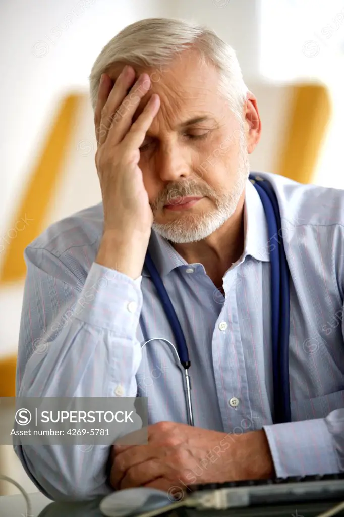 General practitioner looking stressed or tired.
