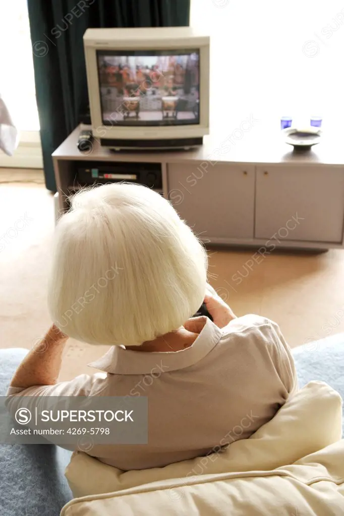 Elderly woman watching TV.