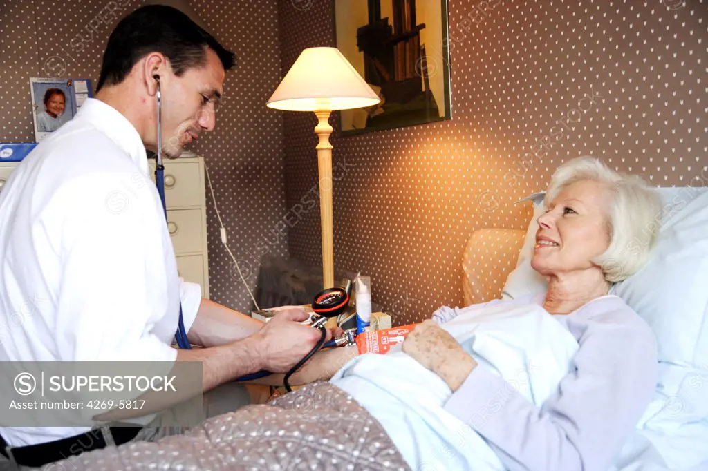 Doctor checking the blood pressure of a patient.