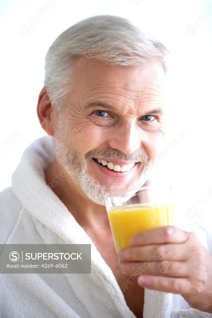 Man drinking orange juice.