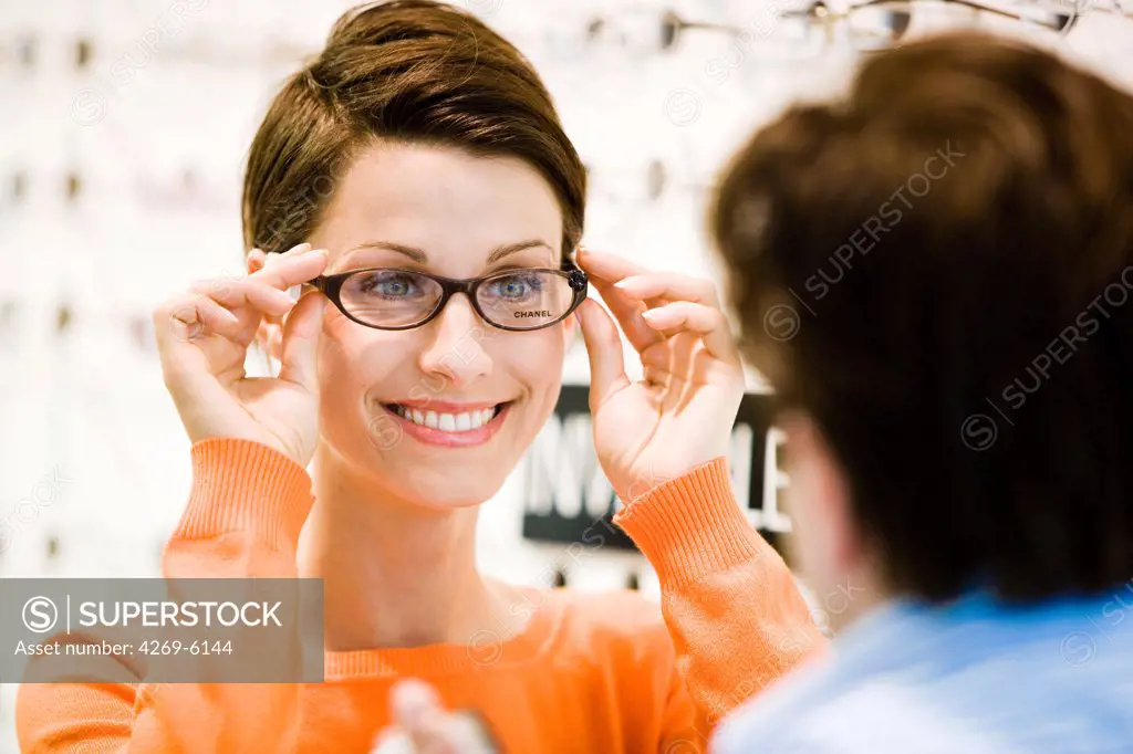 Woman trying prescription glasses at the optician's.