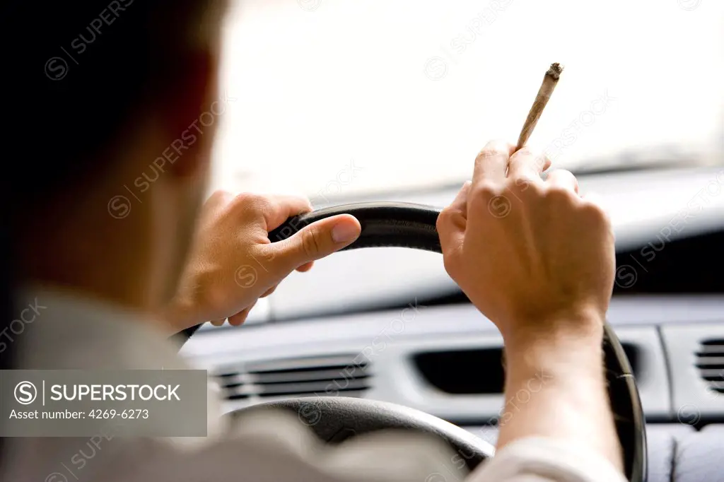Man smoking a joint while driving.