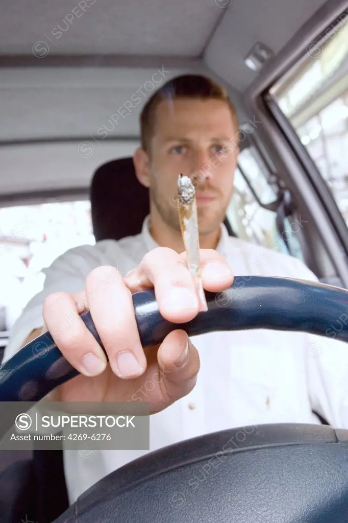 Man smoking a joint while driving.