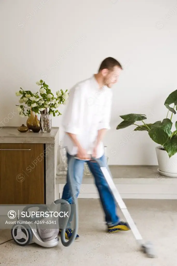 Man vacuuming.