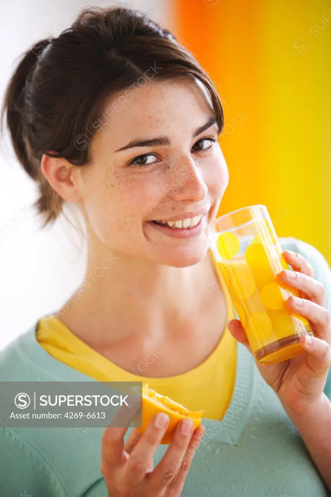 Woman drinking orange juice.