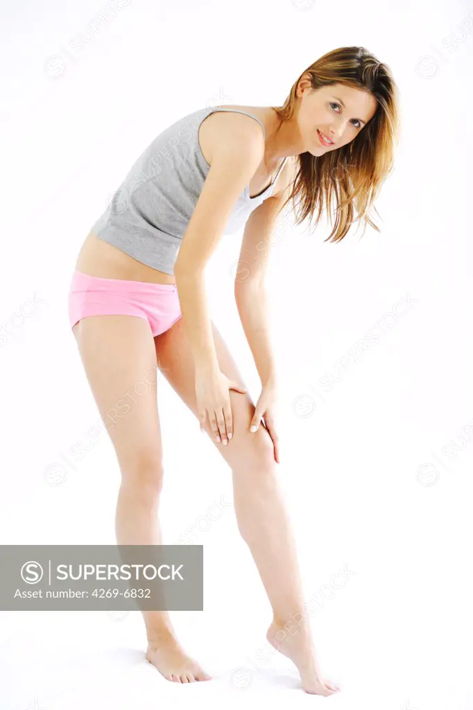 Woman suffering from a pain in the knee.