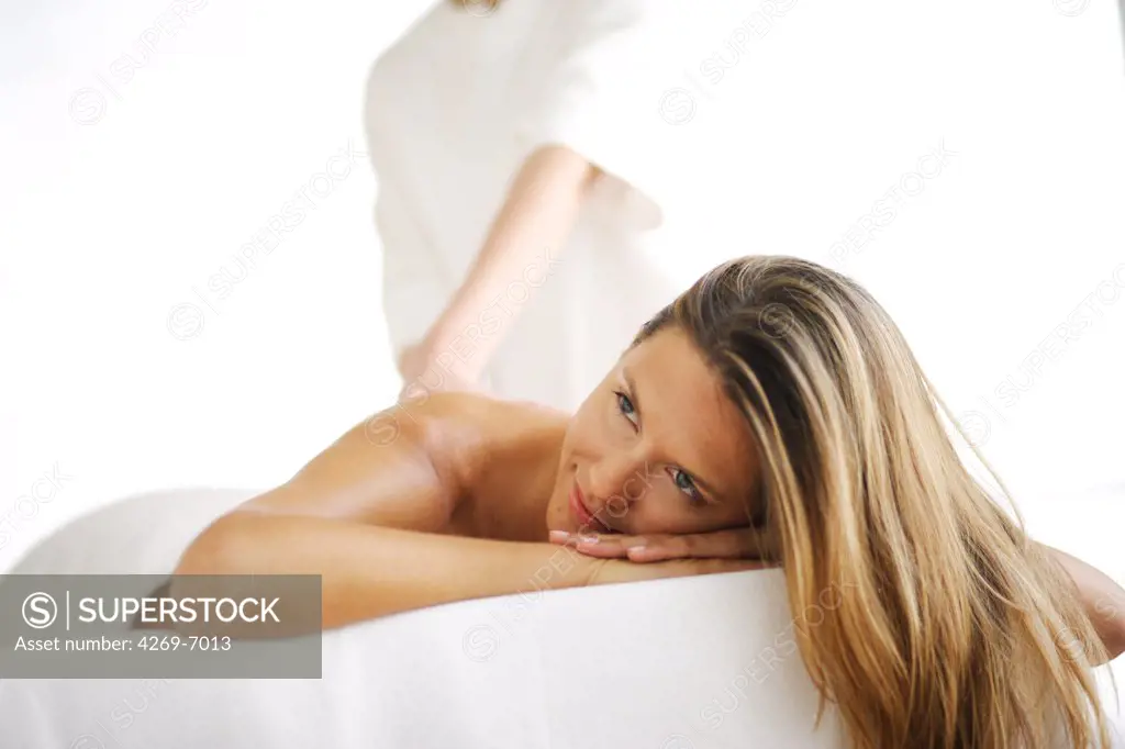 Woman receiving a back massage.