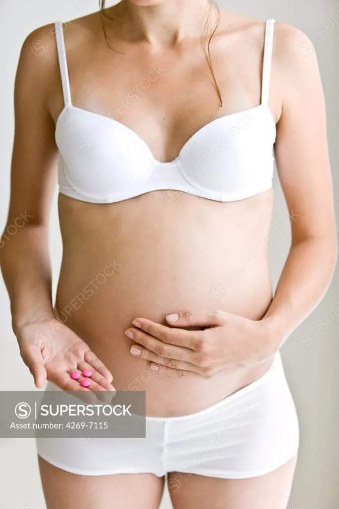 Woman taking medication during pregnancy.