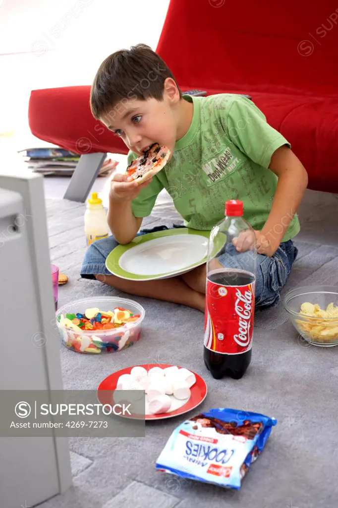 Child snacking while watching TV.
