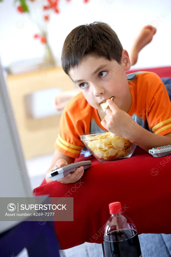 Child snacking while watching TV.