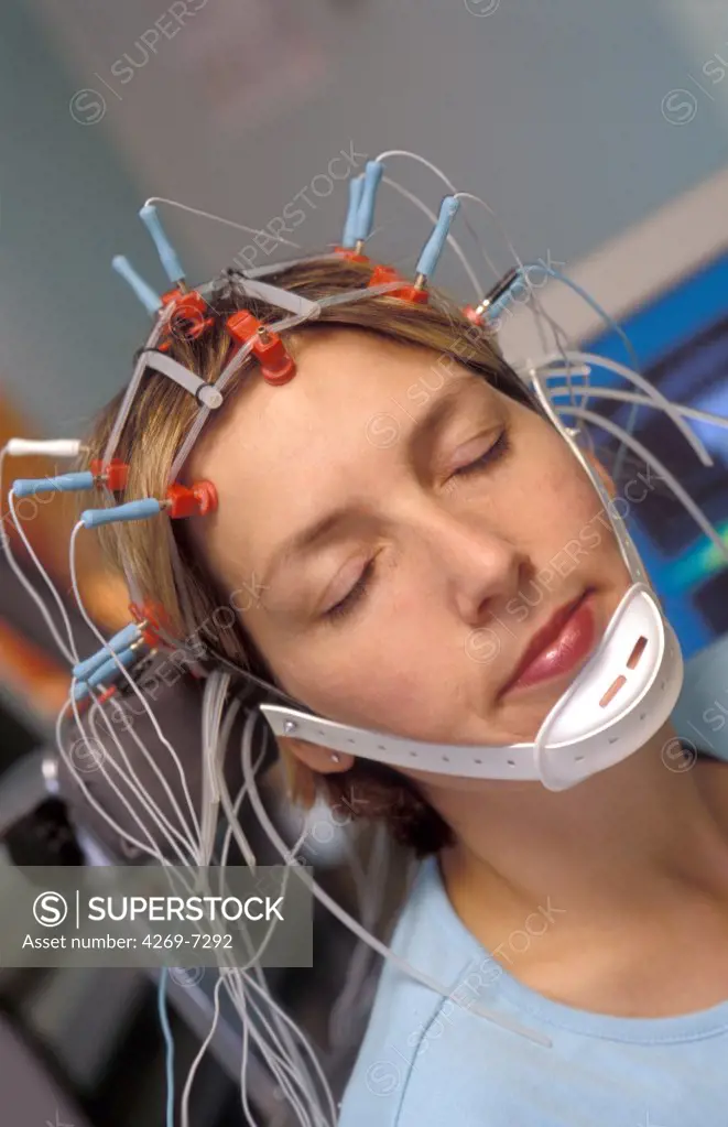 Sleep research laboratory : woman undergoing electroencephalogram to determine the electric activity of her brain during sleep.