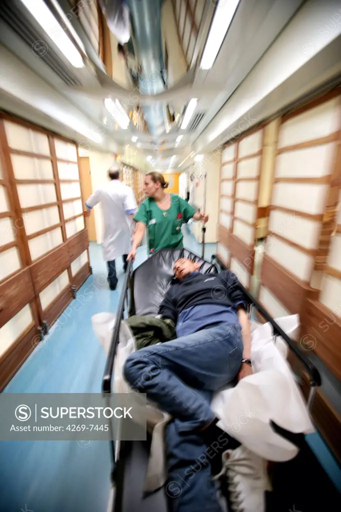 Transport of an unconscious patient on stretcher. Emergency Department, Lariboisière Hospital, Paris, France.